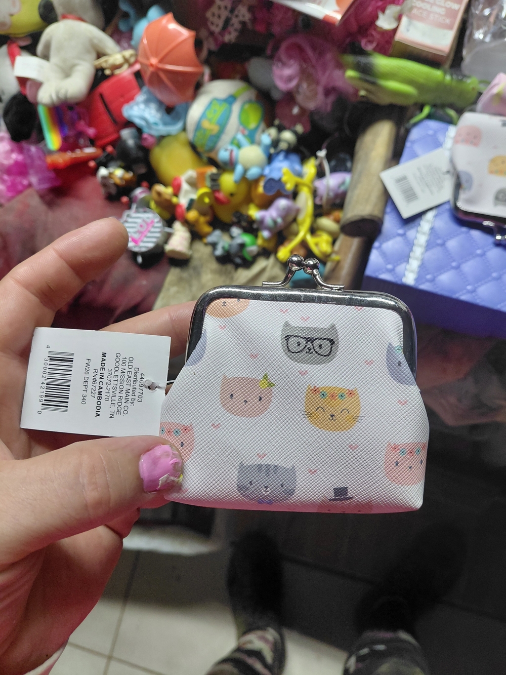 small white kiss-lock coin purse featuring a playful pattern of cartoon cat face